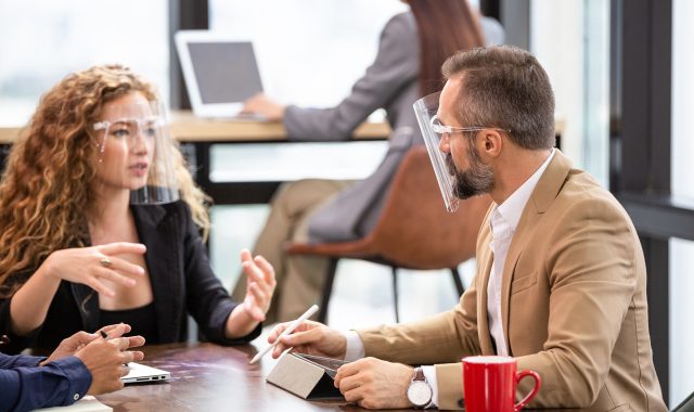 business-man-talking-with-colleague-in-the-office-C7ZT6UZ