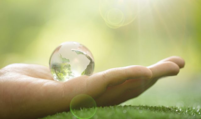 close-up-of-green-planet-in-your-hands-save-earth